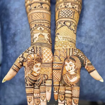 A complete bridal design featuring detailed portraits of the bride and groom on each palm. The arms are decorated with traditional elephant motifs and architectural elements, telling a full story.