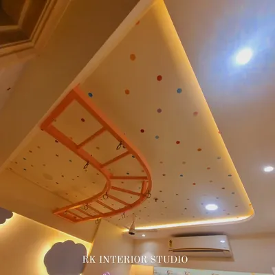 A fun detail from a kids' room ceiling, featuring a polka dot pattern and a custom-made monkey bar for playtime.