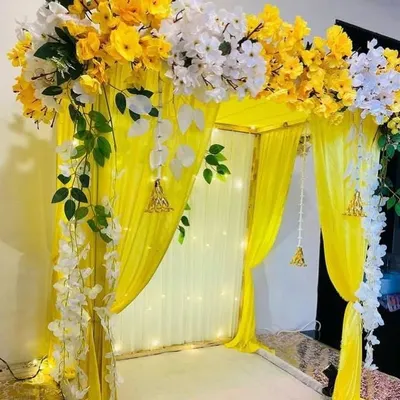 I also offer decorations for festive occasions like Ganesh Chaturthi. This is a simple yet elegant mandap I created using a frame with bright yellow drapes, fairy lights, and an arrangement of artificial flowers on top.
