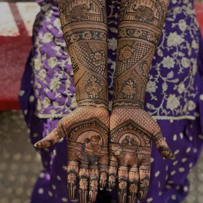 This bride wanted to honor her grandmother, so we placed a beautiful portrait of her aaji right on her palm. It’s such a touching way to include family heritage in your bridal henna.