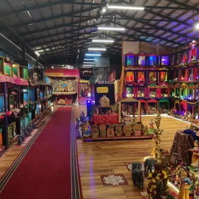 A wide-angle view of the Dhaatu Navaratra Mahotsava exhibition hall. The layout is designed to guide visitors on a journey through different stories and epochs, with a central stage and tiered displays creating a vibrant, multi-level experience.