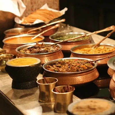 A traditional Indian feast served in authentic copper and stone bowls. This style of presentation is perfect for religious ceremonies and festive events where heritage and authenticity are key.