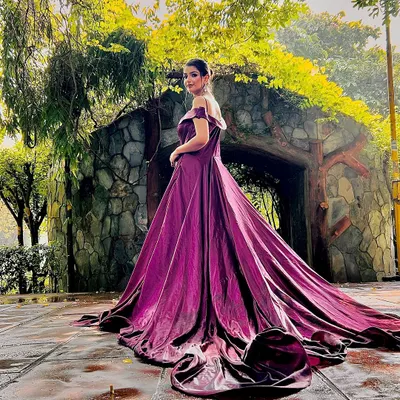 A breathtaking shot of our wine-colored long-trail gown, perfect for a dramatic pre-wedding photoshoot in a scenic location.