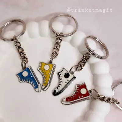 Gifts for the goal-getters. This collection of shoe-themed keychains is perfect for any sneakerhead or sports lover.