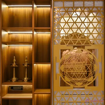 A tranquil corner for prayer and meditation. We designed this pooja unit with intricate geometric jali work on the door, which is beautifully highlighted by warm, integrated LED lighting. The wooden shelves provide ample space for idols and traditional lamps.