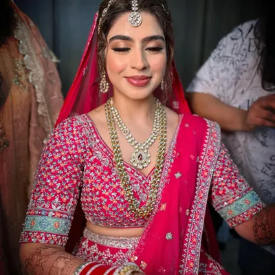 Creating timeless beauty for Jasleen's big day. This look features soft, blended eyeshadow and a classic pink lip to complement her intricately embroidered pink lehenga.