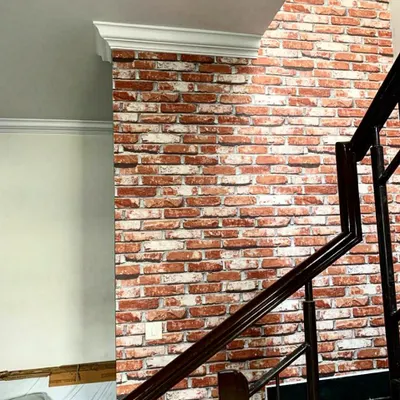 You don't need real bricks to get the classic exposed brick look. This high-quality wallpaper provides a realistic red brick texture, perfect for an industrial or rustic accent wall along a staircase.