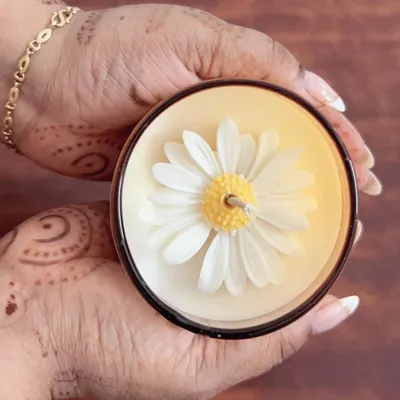 My signature daisy candle, held to show the beautiful detail of the wax flower on top. This is one of my most requested designs.