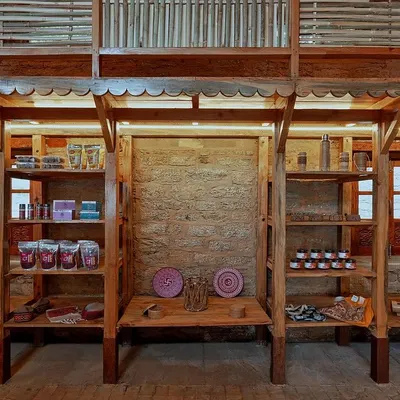 The Sargakhet Handicraft Centre is an adaptive reuse project where we transformed a British-era post office in Mukteshwar. The interior now features versatile wooden columns that double as display racks, showcasing local artisan products against the beautifully restored original stone walls.