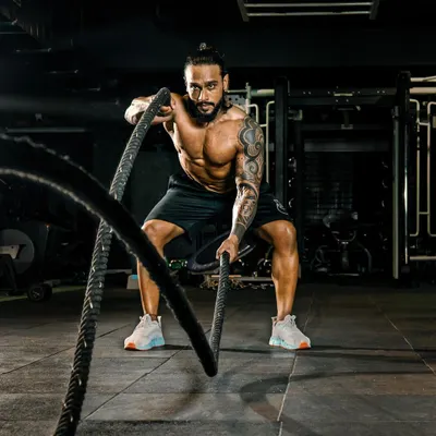 The battle ropes are a fantastic tool for high-intensity interval training (HIIT) and building explosive power. I incorporate functional exercises like this to improve cardiovascular health and muscular endurance.