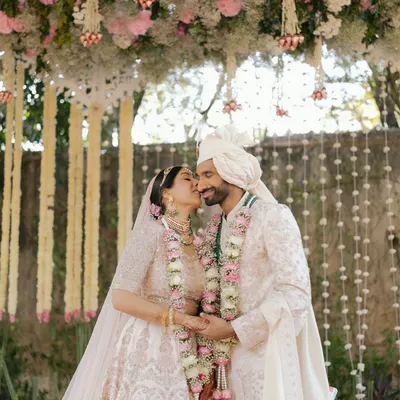 A stolen kiss under a canopy of flowers for Sid and Kanika at the Rambagh Palace in Jaipur. A perfect blend of tradition and romance.