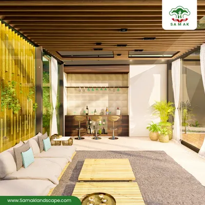 A serene living space where the interior is visually connected to the outdoors. The design features a bamboo-inspired wall screen and large glass panels that frame the exterior greenery, complemented by minimalist furniture and indoor plants to create a calm, natural ambiance.
