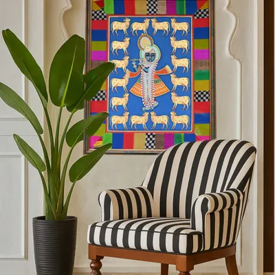 A Pichwai painting I framed for a client, seen here in its new home in Singapore. The custom border, made from colorful fabric scraps, was designed to complement the artwork and create a unique, personal piece of decor.