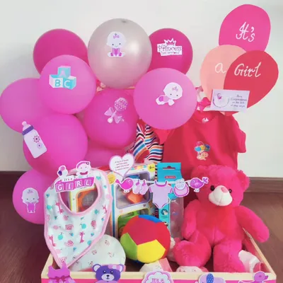 It's a girl! This hamper is a celebration in pink, packed with a teddy bear, a colorful ball, a bib, and a variety of toys and clothes for the new princess.