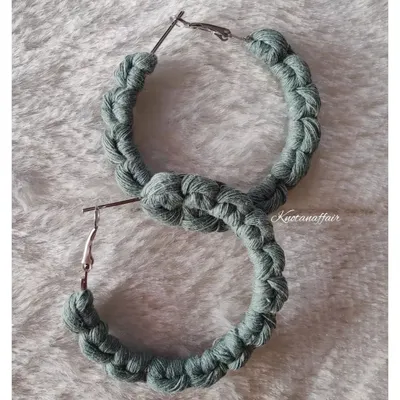 A pair of custom-made macrame hoop earrings in sage green. These were part of a matching set with a hairband for a very special client order.