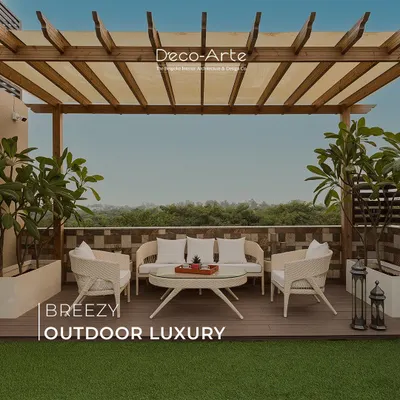 Bask in breezy outdoor luxury on this rooftop terrace. A wooden pergola provides shade over elegant white wicker furniture, creating a serene escape that blends natural comfort with sophisticated design.