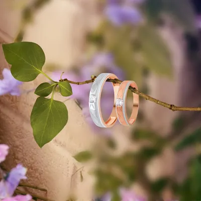 Bound by love, wrapped in gold. The forever begins with these elegant couple rings of promise, featuring a single diamond in a modern two-tone design.