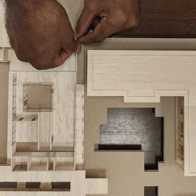 Our master model maker, Vijay, meticulously crafting a detailed model. Physical models are fundamental to our design process, helping us understand scale, light, and spatial relationships in a way that digital tools alone cannot.