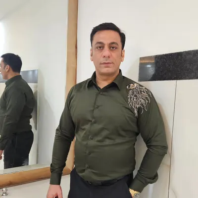 The owner, looking sharp in one of his own creations. This olive green shirt with shoulder embroidery is a perfect example of our smart casual wear.