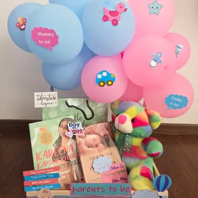 A perfect gift for expecting parents, this hamper includes pregnancy books like Kareena Kapoor's guide, a colorful plush toy, and fun 'Mommy to be' and 'Daddy to be' balloons. It's a celebration of the adventure ahead.