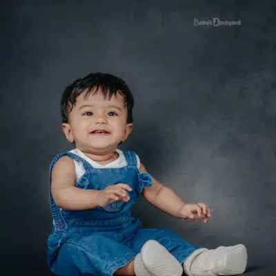 Capturing the wonder of new beginnings. A simple denim overall and a happy smile are all you need.