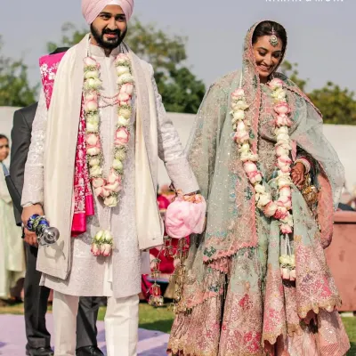 A full view of my client's wedding day ensemble. The soft pastel sherwani, paired with a churidar and matching juttis, creates a cohesive and elegant look. It is designed for comfort and movement, ensuring style feels effortless throughout the celebration.