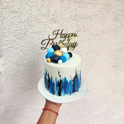 An abstract design for a modern celebration. I used a palette knife to create these bold blue and black brushstrokes on a white chocolate ganache base, topped with coordinating chocolate spheres.
