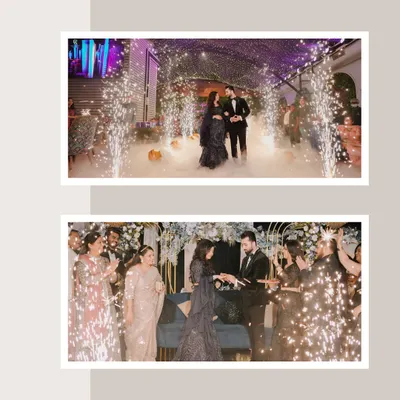A spectacular engagement party entrance. The couple is framed by sparklers and smoke, creating a magical and celebratory atmosphere as they walk in.