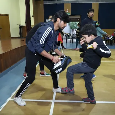 A young warrior learning how to deliver a proper kick. My kids' classes focus on building fundamental skills in a safe and encouraging environment.