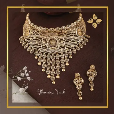 An exquisite example of our filigree work, this gleaming gold choker and earring set is incredibly detailed yet lightweight, showcasing superior craftsmanship.