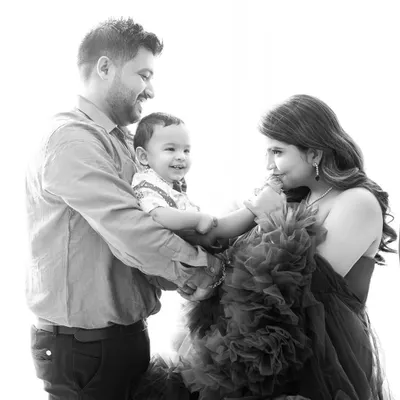 A candid black and white photo of a family sharing a happy moment. This style emphasizes the emotion and connection between them.
