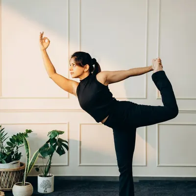Natarajasana (Dancer's Pose) requires balance, strength, and focus. Here, the practitioner holds the pose with a calm gaze and steady mudra.