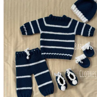 A beautiful flat lay of our complete navy and white striped winter baby set. This five-piece collection is one of our bestsellers and makes for a truly special baby shower gift.
