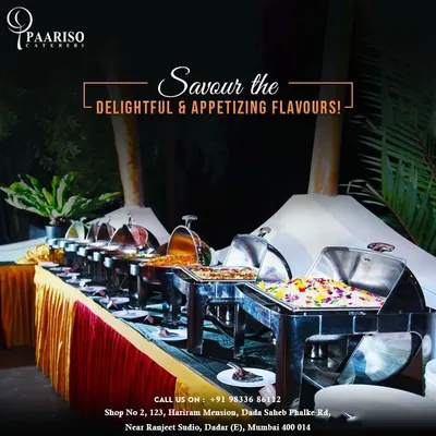 An evening buffet setup for an outdoor event, featuring a long line of stainless steel chafing dishes ready to serve a variety of hot dishes. This arrangement ensures food is kept at the perfect temperature for guests to enjoy throughout the celebration.