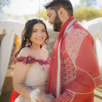 A quiet moment amidst the fun of the Haldi ceremony. The couple shares a gentle look, a calm island in a sea of yellow.