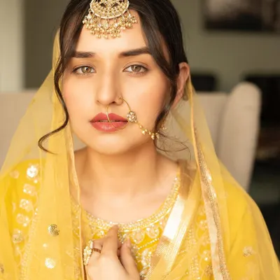 A beautiful Heeramandi-inspired look. I created a dewy, royal makeup look with defined eyes and a soft lip, paired with a classic low bun and face-framing tendrils.