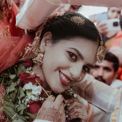 A beautiful close-up of the bride's radiant smile as she's welcomed by the groom's family. This is a perfect example of the happy, candid moments I look for during a wedding.