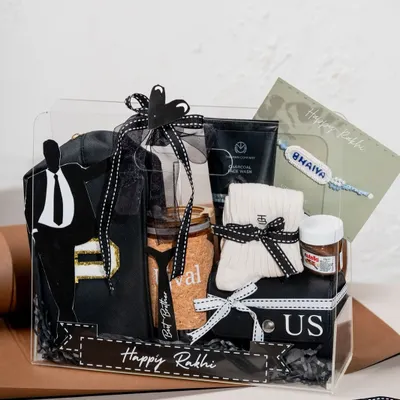 Our Classic Black Box is a bestseller for Raksha Bandhan. This bespoke hamper for brothers includes a custom-designed t-shirt, grooming products, and treats, all elegantly packed in a clear acrylic box.