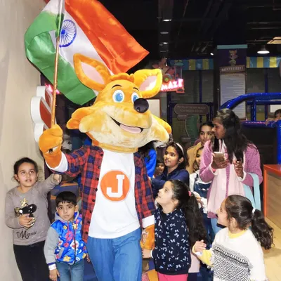 J the Fox leads the parade during our Independence Day celebration, waving the flag with pride.