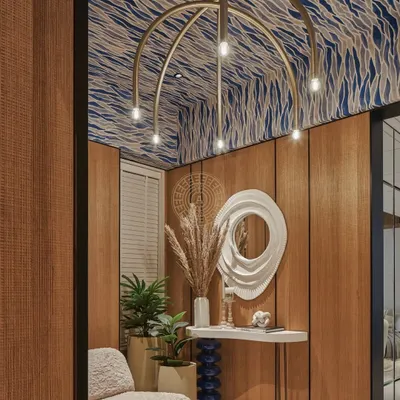 The entrance foyer for the EON Group's show apartment makes a bold first impression. We used their signature royal blue on the ceiling, paired with wood-paneled walls and a sculptural chandelier to create a warm and dramatic welcome.