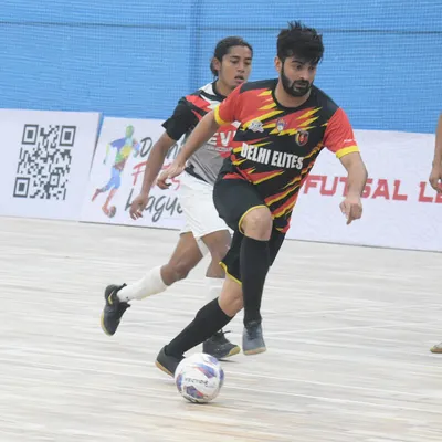 I don't just coach from the sidelines. Here I am in the middle of the action during a futsal league match, demonstrating the skills and tactical awareness I expect from my players.