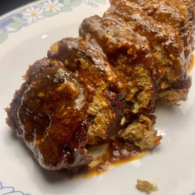 A close up of my glazed pork meatloaf, sliced and ready to eat. I use juicy pork mince with the right amount of fat and fresh herbs from Coorg to create this flavourful loaf.