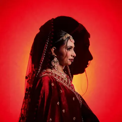 A highly artistic and creative bridal portrait using shadows. The silhouette of the groom's face is cast upon the bride, symbolizing their union in a visually stunning and unique way. This is an example of my signature conceptual shots.