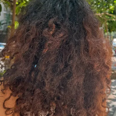 Before: The hair is healthy but lacks dimension, causing the curls to appear less defined.