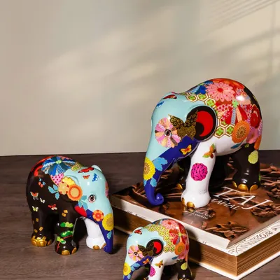 A family of elephants from the Elephant Parade, each adorned with a vibrant, floral pattern. These hand-painted sculptures are a celebration of life and color, and each purchase helps support elephant conservation.