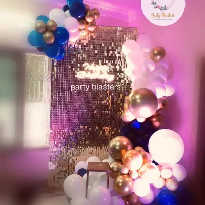 We build modern and stylish photo opportunities like this shimmering gold sequin wall. Paired with a custom organic balloon garland in the company's brand colors of blue, white, and gold, it creates a perfect, Instagram-worthy spot for any corporate party.