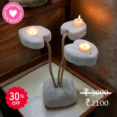 Light up your home with love. This handmade candle holder features three heart-shaped stones, creating a beautiful and romantic ambiance when lit. It's a perfect piece to add warmth to any space.