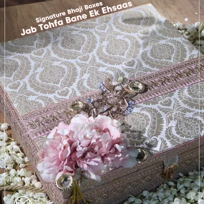 My signature Bhaji Box, where the gift becomes an 'ehsaas' or a feeling. The box itself is a work of art, with traditional paisley fabric and floral adornments, promising something truly special inside.