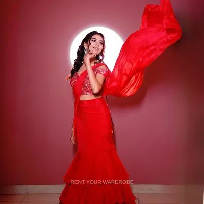 The highlight of this red drape saree is the dramatic, flowing pallu. This shot captures the movement and makes the outfit look so dynamic and glamorous.