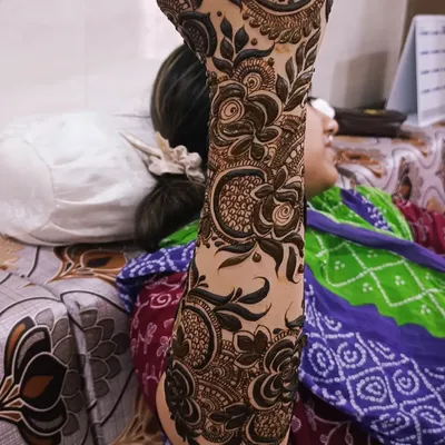 This is a close-up of a Dubai-style floral design on the arm. The focus is on bold, shaded flowers and leaves, creating a pattern that stands out beautifully against the skin.